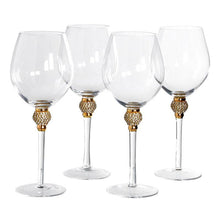Load image into Gallery viewer, a group of wine glasses sitting on a table 