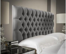 Load image into Gallery viewer, a bed with a white comforter and pillows
